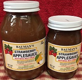 A picture of several jars of Bauman's strawberry applesauce